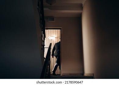 Silhouette Of A Young Man Entering The Door