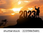 Silhouette Young man Graduation in 2023 years, education congratulation concept, Freedom and Happy new year, success in the future goal and passing time.copy space.