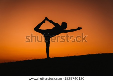 Similar – Two sisters doing gymnastics at sunset