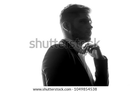 Silhouette of young man portrait with hand on studio isolated white background. Close up.