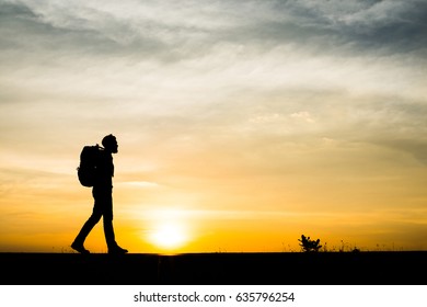 Silhouette of young man traveler.