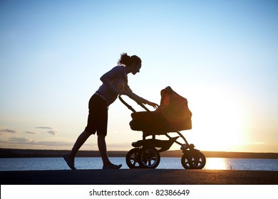 Silhouette of  young mother enjoying motherhood - Powered by Shutterstock