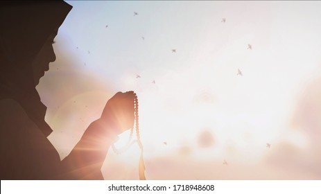 Silhouette Young Muslim Woman Hijab Honesty Pray To God On Sunset Panoramic Mosque Background Concept For Eid Mubarak, Life And Spiritual Of Islam Girl Fasting In Ramadan, Indonesian Civilian People