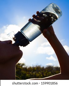 Silhouette Of Young Woman Drinking Water