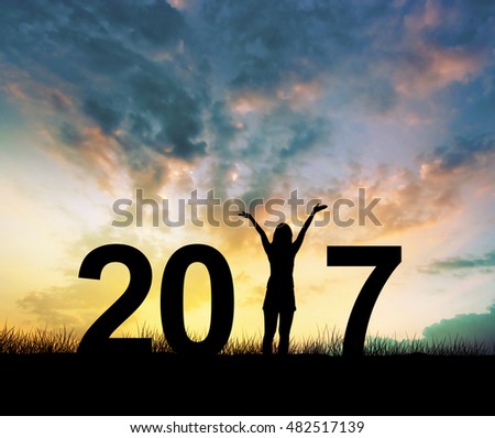 Silhouette young woman Enjoying on the hill and 2017 years while celebrating new year