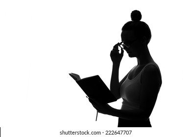 Silhouette Of Young Woman Reading Book Against White Background 