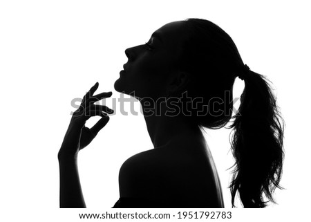 The silhouette of a young woman's head in profile on a white background.