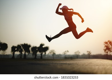 Silhouette young women runner jump on the road during sun rise - Shutterstock ID 1831023253