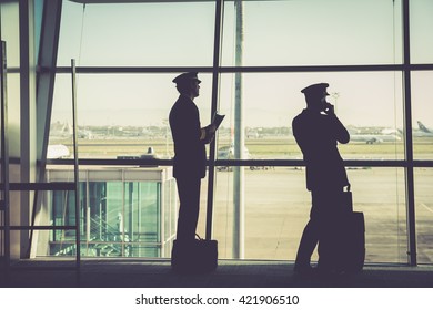 Silhouetted Airline Member Crew Inside Aiport Terminal