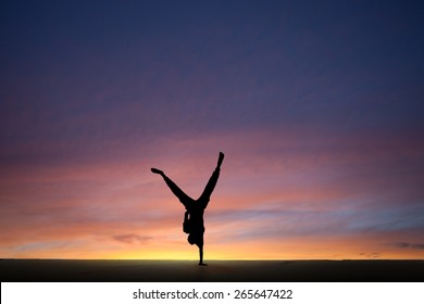 silhouetted gymnast dong onehanded handstand sunset stock photo edit now 265647422 silhouetted gymnast dong onehanded