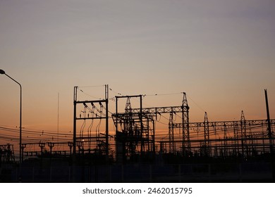 Silhouetted high-voltage electric tower in the dramatic sunset sky - Powered by Shutterstock