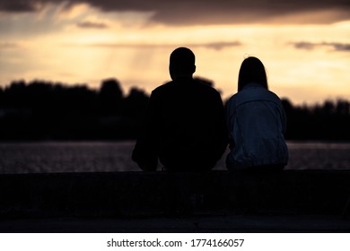 Silhouetted loving couple at sunset.