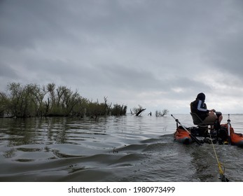 Silhouetted Man On A Pontoon Boat