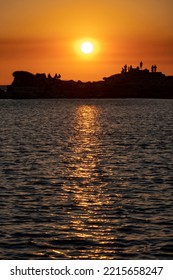 Silhouetted People Watching Sunset In Knidos, Greek City Of Ancient Caria And Part Of The Dorian Hexapolis, In Datca Peninsula, Southwestern Turkey.