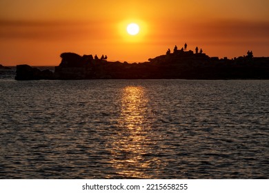 Silhouetted People Watching Sunset In Knidos, Greek City Of Ancient Caria And Part Of The Dorian Hexapolis, In Datca Peninsula, Southwestern Turkey.