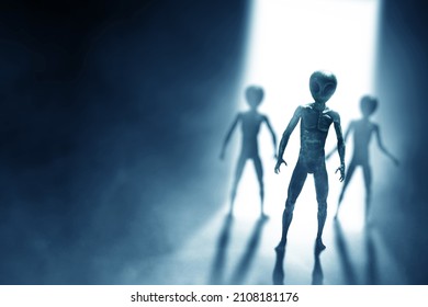 Silhouettes of aliens creature on dark background
