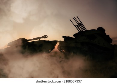 Silhouettes Of Armored Fighting Vehicle And Tank On Battlefield
