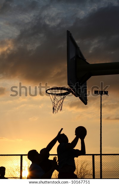 Silhouettes Of Basketball Players At The Sunset Stock Photo 10167751