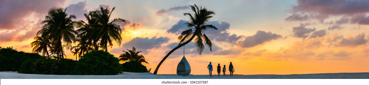 Silhouettes Of Beautiful Family Of Four With Kids At Tropical Beach During Sunset, Panoramic Photo Perfect For Banner