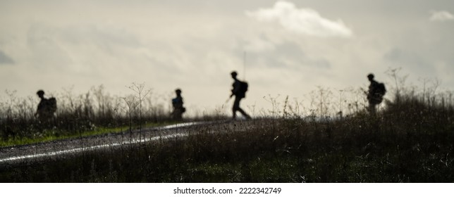 Silhouettes Of British Army Soldiers On A Cross Country Tab, Wiltshire UK 