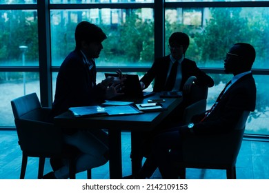 Silhouettes Of Business People In A Conference Room.