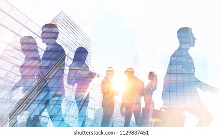 Silhouettes of business people walking and talking against a modern cityscape. Toned image double exposure mock up - Powered by Shutterstock