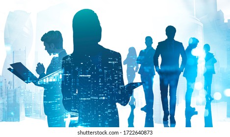 Silhouettes Of Business People Working Together In City With Double Exposure Of Blurry Night Cityscape. Concept Of Teamwork And Business Meeting. Toned Image