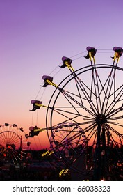 Silhouettes Of Carnival Rides Under Sunset