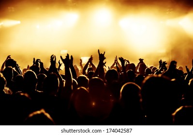 Silhouettes Of Concert Crowd In Front Of Bright Stage Lights