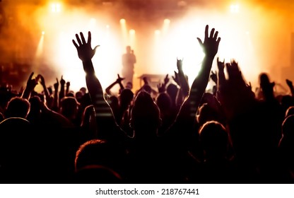 Silhouettes Of Concert Crowd In Front Of Bright Stage Lights