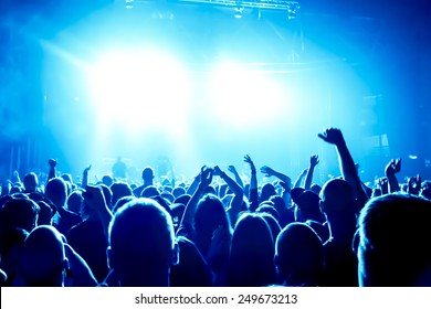 Silhouettes Of Concert Crowd In Front Of Bright Stage Lights