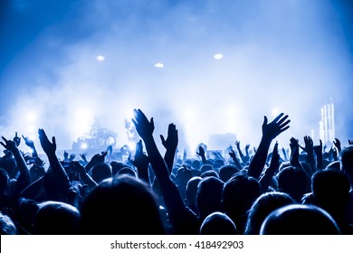 Silhouettes Of Concert Crowd In Front Of Bright Stage Lights