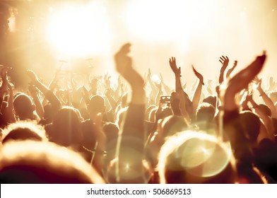 Silhouettes Of Concert Crowd In Front Of Bright Stage Lights