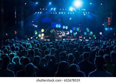 silhouettes of concert crowd in front of bright stage lights. motion image - Shutterstock ID 652678519