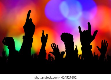 Silhouettes Of Concert Crowd Hands Supporting Band Performing Live Music On Stage, Young People On Rock Gig Enjoying.