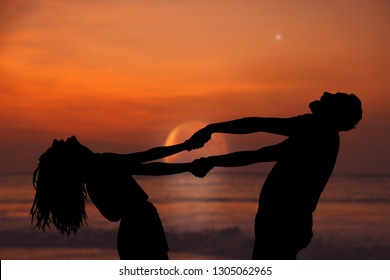 Silhouettes Of A Couple Dancing Under The Rising Moon And Stars Over The Ocean / Sea Horizon. My Astronomy Work.