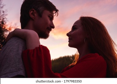  Silhouettes Of Couple  On Pink Sunset Sky Background. Valentine Day Concept.