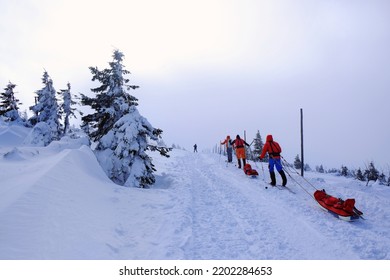 Silhouettes Of Cross Country Skiers With With Sledges On Mountain Trail In Beautiful Winter Scenery. During Trip Around Sniezka Mount, Karkonosze Mountains (Giant Mountains), Poland