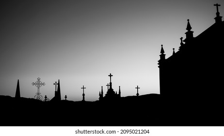 Silhouettes Of Crosses In The Cemetery During Dawn. Black And White Photo.