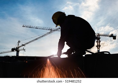Silhouettes of expatriate worker to cutting steel in construction site with Oxy-Propane cutting