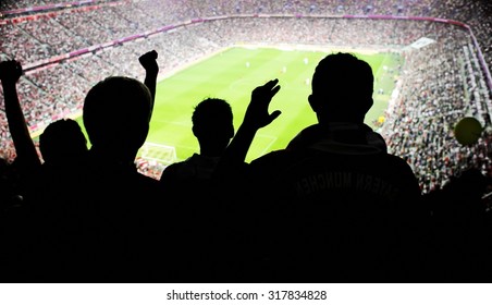 Silhouettes Of Fans Celebrating A Goal On Football Match