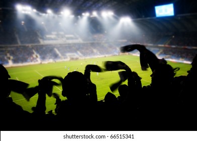 Silhouettes Of Fans Celebrating A Goal On Football / Soccer Match