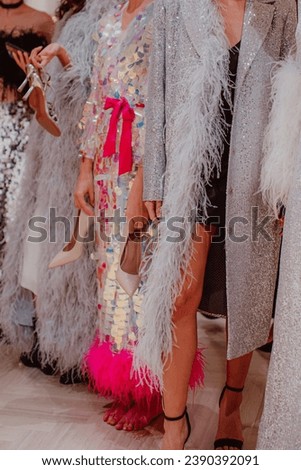 Silhouettes of fashion models on backstage dressed in a long Haute couture boudoir dresses outfits. Preparation before the fashion show.