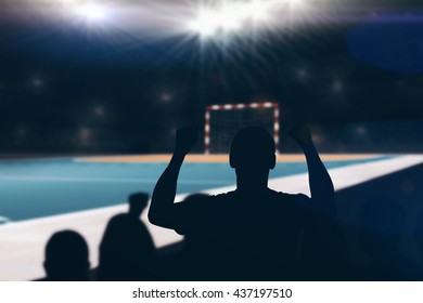 Silhouettes of football supporters against handball field indoor - Powered by Shutterstock