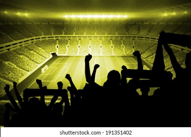 Silhouettes of football supporters against large football stadium with lights - Shutterstock ID 191351402