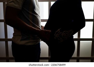 Silhouettes Of Future Parents With Hands Near The Belly. Pregnancy Photoshoot