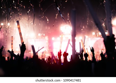 silhouettes of hand in concert.Light from the stage. - Shutterstock ID 1090417481