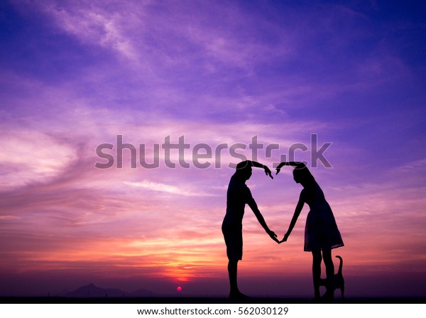 Silhouettes wall art of man and woman looking romantic sky in twilight time