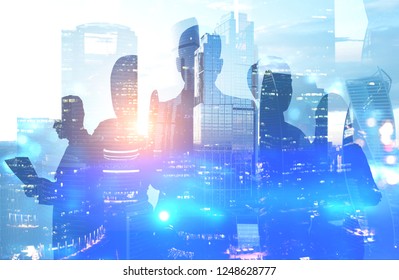 Silhouettes of managers over evening cityscape background. Concept of leadership in modern company. Toned image double exposure - Shutterstock ID 1248628777