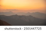 Silhouettes of mountains in a beautiful gentle haze, mountains at sunset or sunrise, natural background